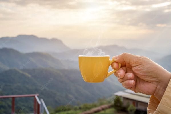 hand holding white cup hot espresso coffee mugs nature view mountain landscape morning with sunlight 38161 1380